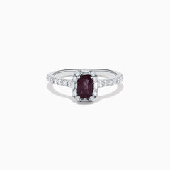 The Effy Hematian 14K White Gold Ring features a cushion-cut alexandrite center stone, surrounded by a diamond halo and additional diamonds set along the band.