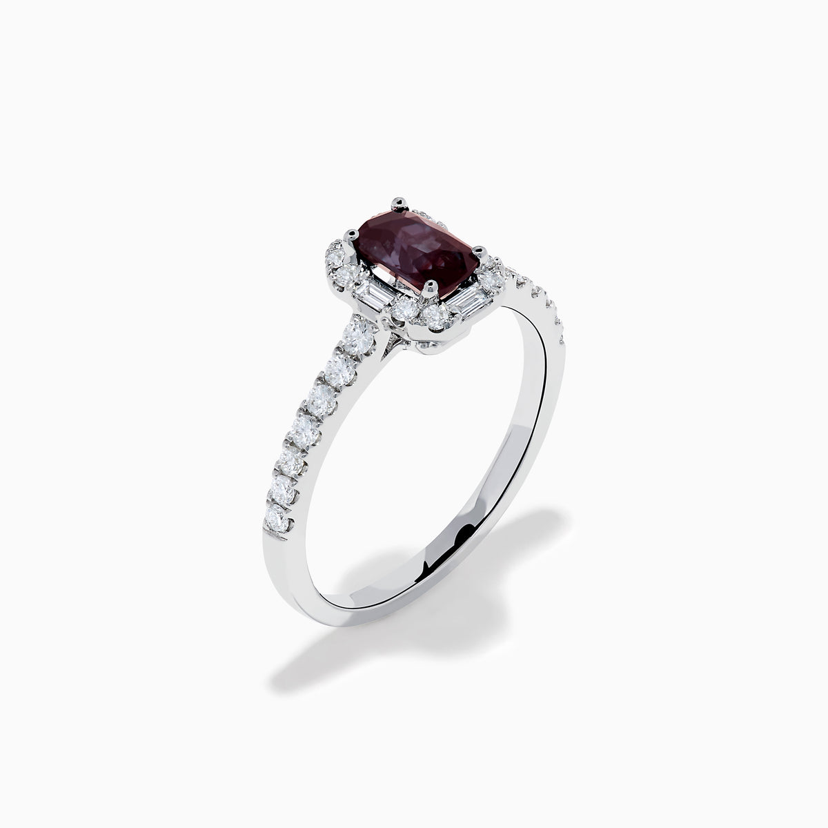 The Effy Hematian 14K White Gold Ring features a cushion-cut alexandrite center stone, surrounded by a diamond halo and additional diamonds set along the band.