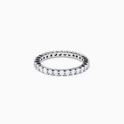 The 14K White Gold Prong Set Diamond Eternity Band, 1.00 TCW, showcases a continuous row of round white diamonds in a prong set design, shown on a white background.