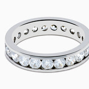 The 14K White Gold Channel Set Diamond Eternity Band, 2.00 TCW, showcases a continuous row of round diamonds set in white gold, elegantly displayed on a plain white background.