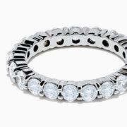 The 14K White Gold Prong Set Diamond Eternity Band, 2.00 TCW, features round clear diamonds encircling the ring and is displayed on a plain white background.