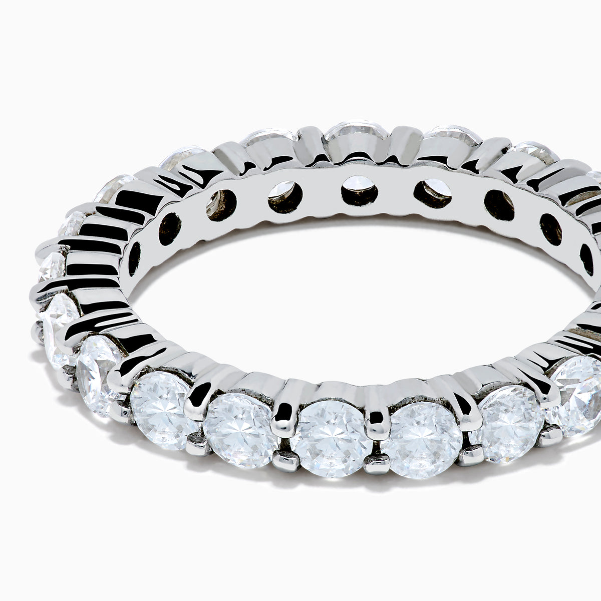 The 14K White Gold Prong Set Diamond Eternity Band, 2.00 TCW, features round clear diamonds encircling the ring and is displayed on a plain white background.