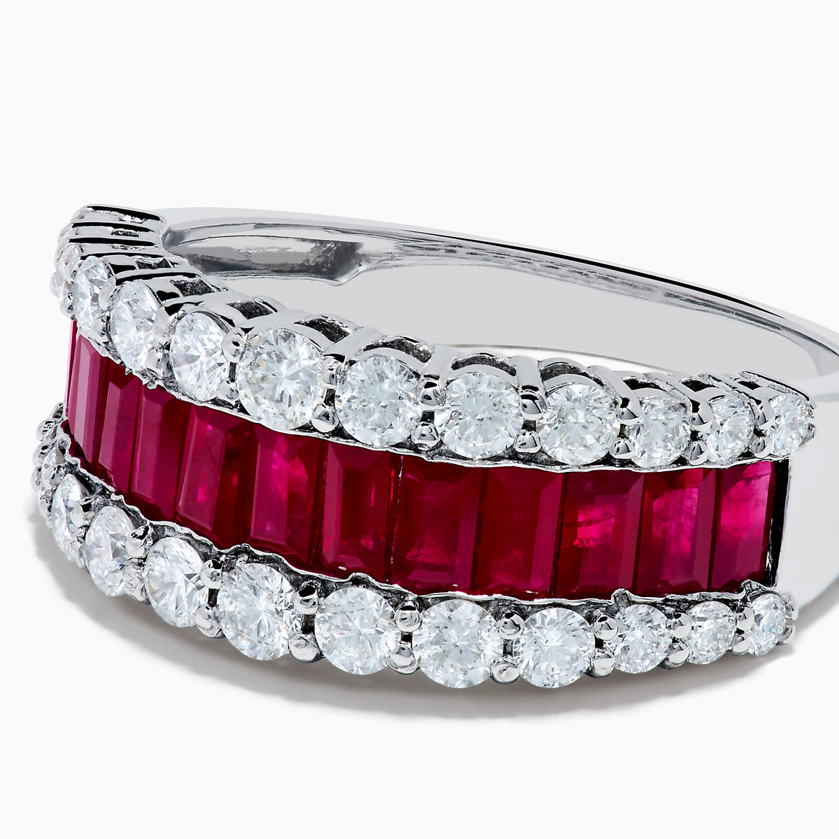 The Ruby Royale 14K White Gold Ruby and Diamond Wide Band showcases a central row of rectangular rubies flanked by sparkling round diamonds, all elegantly set in white gold against a plain white background.