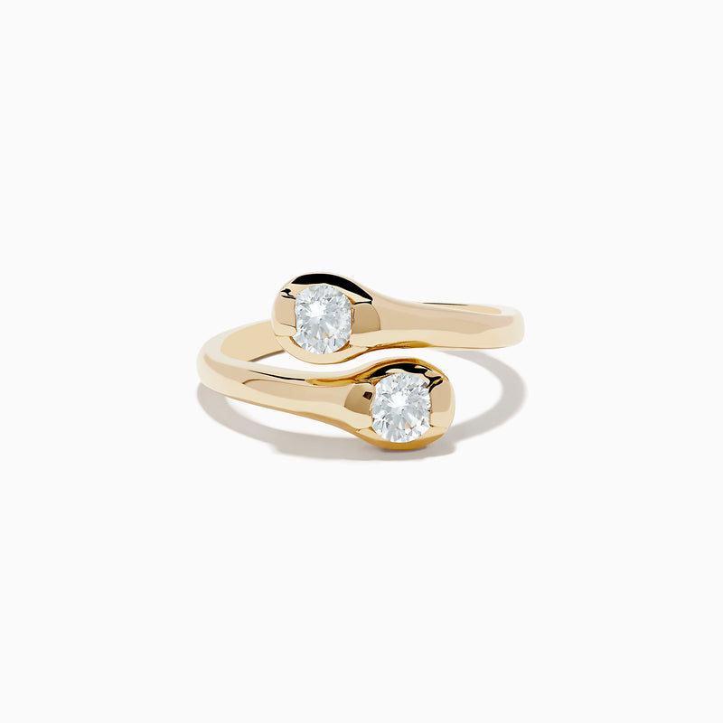 The DOro 14K Yellow Gold Two-of-Us Diamond Ring, 0.59 TCW, showcases two oval-cut diamonds on each end of a bypass band that elegantly curves around the stones.