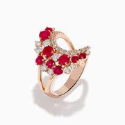 The Ruby Royale 14K Rose Gold Ruby and Diamond Wave Ring features a heart-shaped open design with clusters of round red rubies and sparkling white diamonds set along the band in elegant floral patterns.