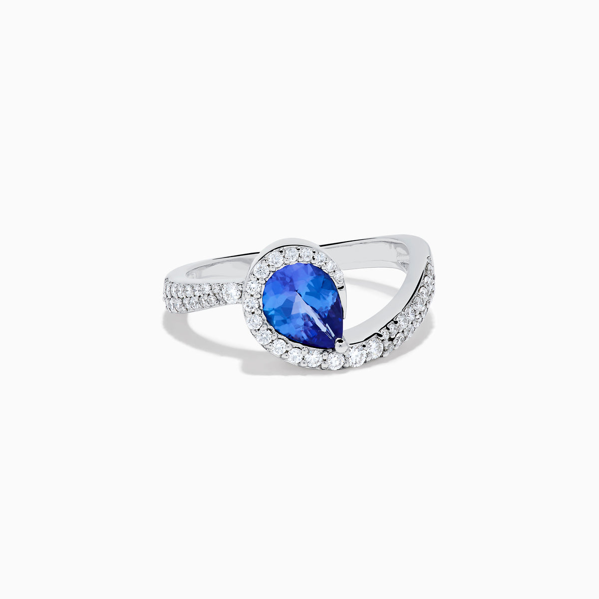 The Nahla 14K White Gold Tanzanite and Diamond Pear Swirl Ring showcases a pear-shaped blue tanzanite center, haloed by diamonds and accented with diamonds along a sweeping band.