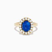 The Royale Bleu 18K Yellow Gold Blue Sapphire and Diamond Halo Ring showcases a striking oval blue sapphire centerpiece surrounded by a sparkling diamond halo.