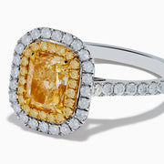 The 18K Gold Yellow and White Double Halo GIA Certified Diamond Ring showcases a large rectangular yellow diamond center, framed by double halos of round white diamonds and a diamond-adorned band.