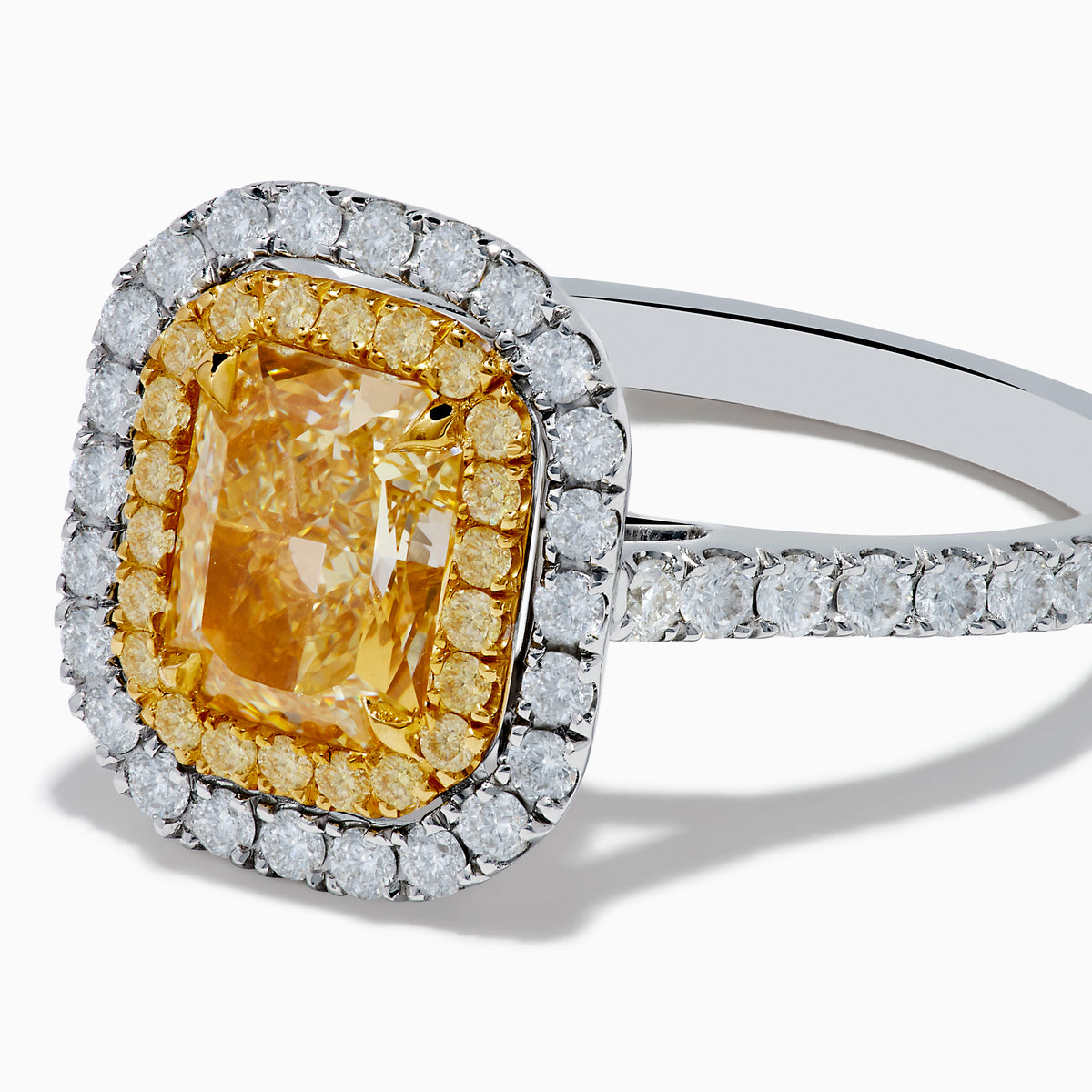 The 18K Gold Yellow and White Double Halo GIA Certified Diamond Ring showcases a large rectangular yellow diamond center, framed by double halos of round white diamonds and a diamond-adorned band.