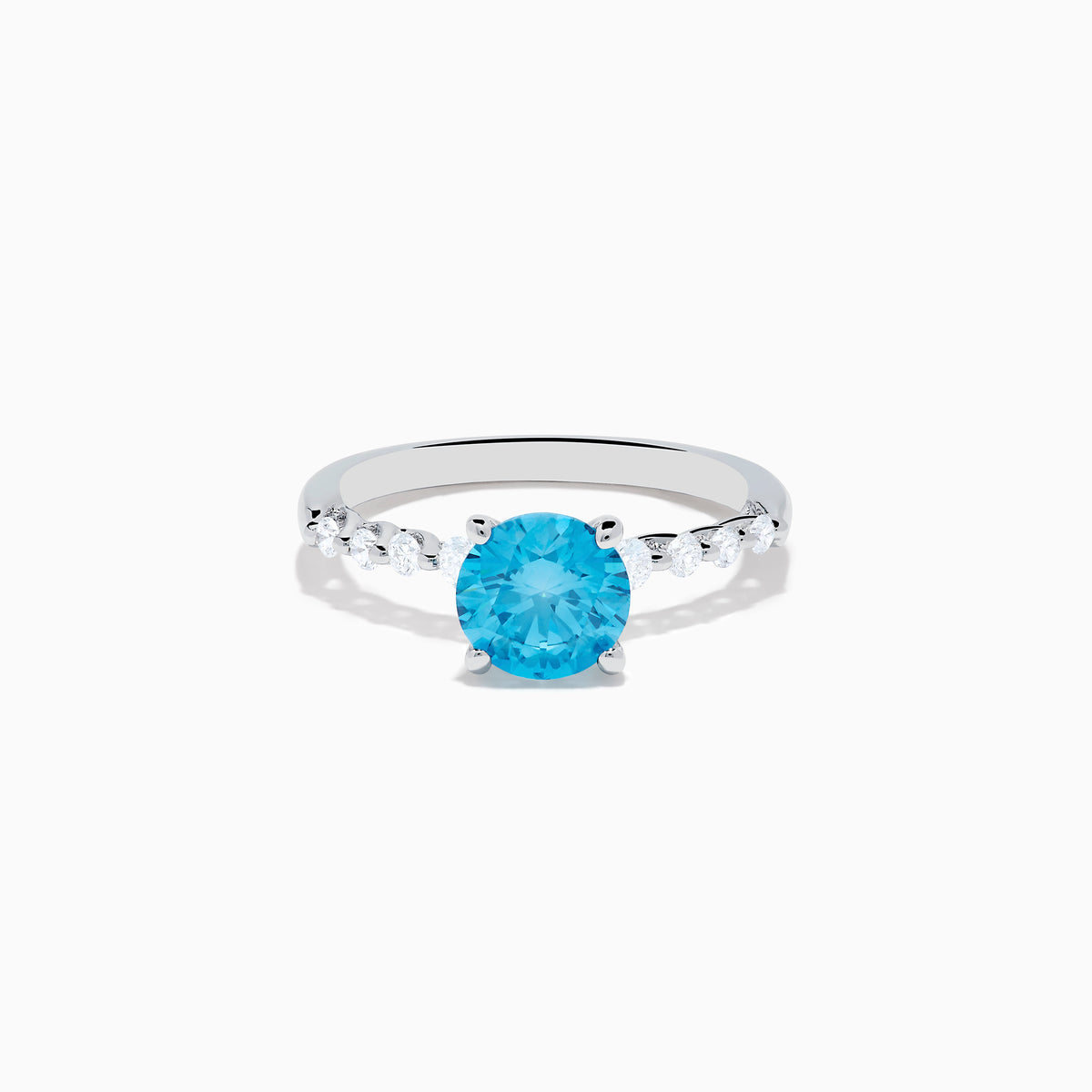 The Lab Grown Blue and White Diamond Ring set in 14K White Gold features a large round blue and white diamond at the center, accented by smaller clear stones, displayed against a white background.