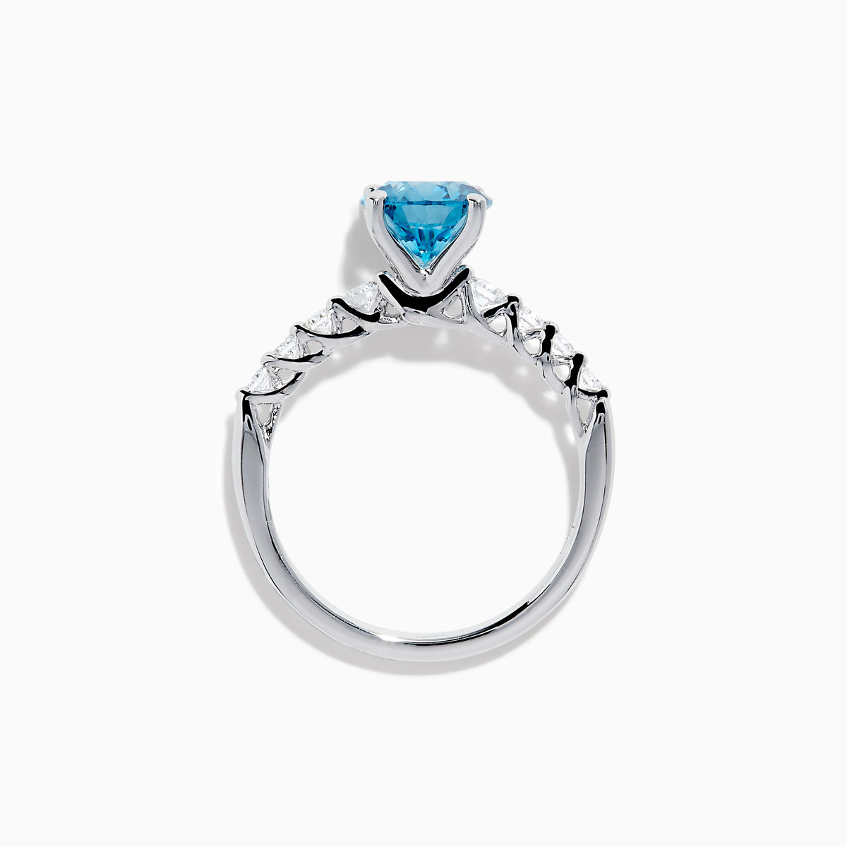 The Lab Grown Blue and White Diamond Ring set in 14K White Gold features a large round blue and white diamond at the center, accented by smaller clear stones, displayed against a white background.