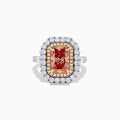 The Lab Grown Pink Diamond Double Halo Cocktail Ring in 14K White Gold features a rectangular pink diamond center, with white and yellow diamonds on a silver band, displayed against a white background.