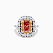 The Lab Grown Pink Diamond Double Halo Cocktail Ring in 14K White Gold features a rectangular pink diamond center, with white and yellow diamonds on a silver band, displayed against a white background.