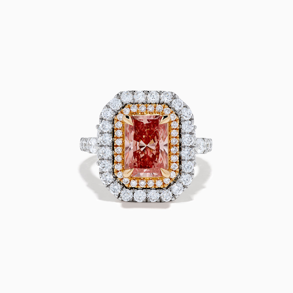 The Lab Grown Pink Diamond Double Halo Cocktail Ring in 14K White Gold features a rectangular pink diamond center, with white and yellow diamonds on a silver band, displayed against a white background.