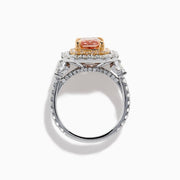 The Lab Grown Pink Diamond Double Halo Cocktail Ring in 14K White Gold features a rectangular pink diamond center, with white and yellow diamonds on a silver band, displayed against a white background.