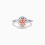 The Lab Grown Pink and White Diamond Halo Ring in 14K Two Tone Gold features a pear-shaped pink center, a halo of white diamonds, and a diamond-studded band, shown on a white background.