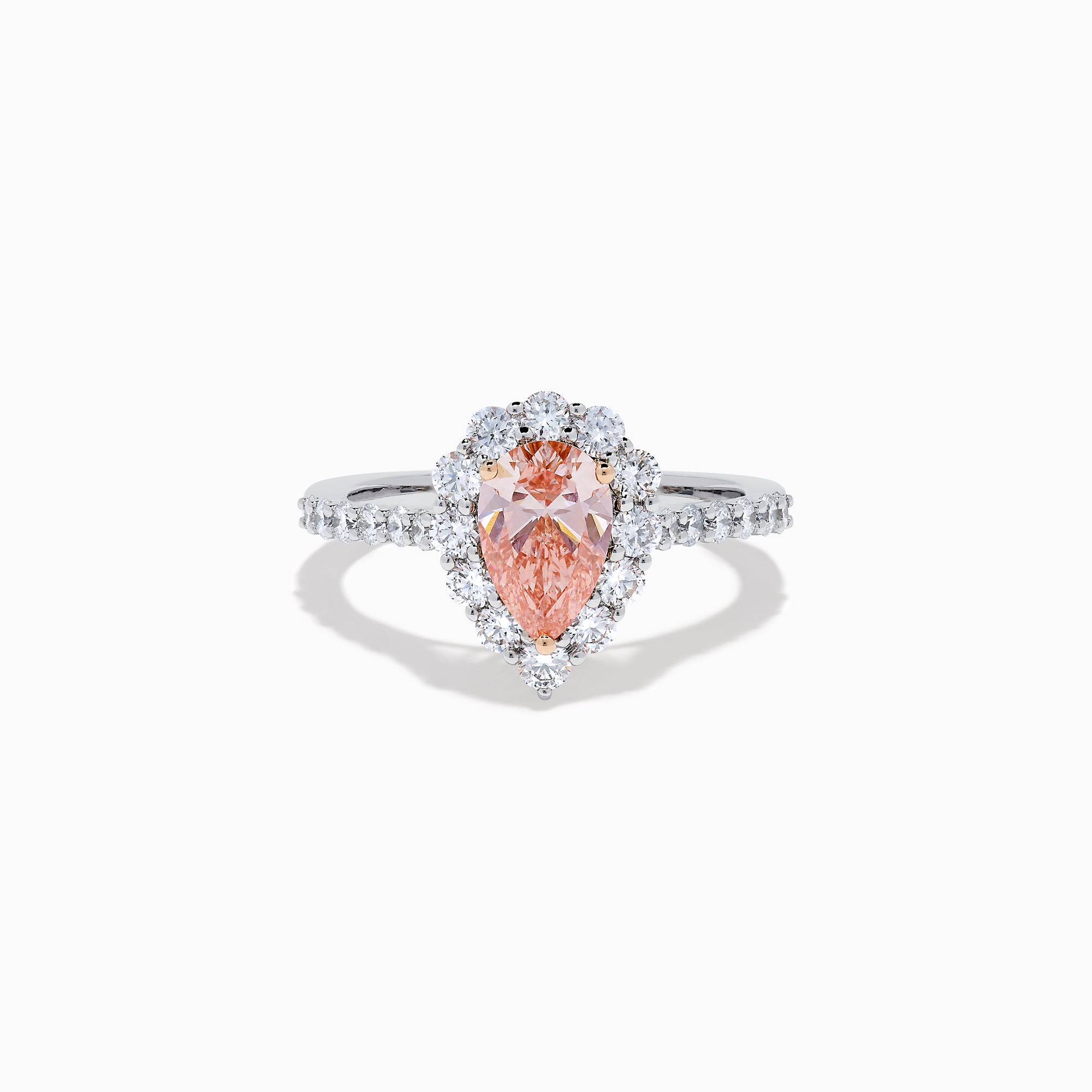 The Lab Grown Pink and White Diamond Halo Ring in 14K Two Tone Gold features a pear-shaped pink center, a halo of white diamonds, and a diamond-studded band, shown on a white background.