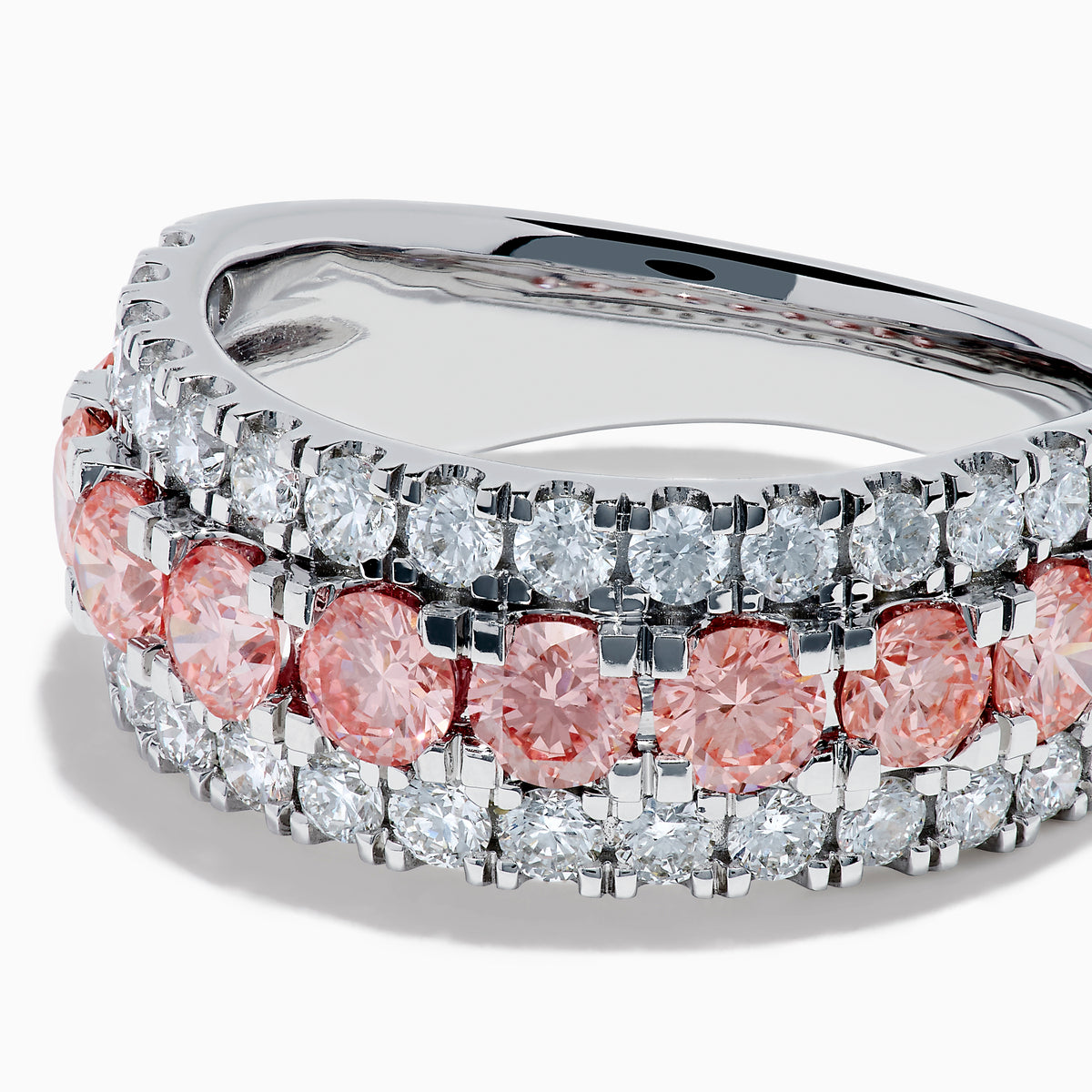 The Lab Grown Pink and White Diamond Wide Band Ring in 14K White Gold features a central row of pink gemstones bordered by sparkling white diamonds on a wide, polished band, beautifully set against a white background.