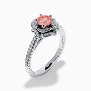 The Lab Grown Pink and White Diamond Rose Ring in 14K White Gold features a round pink center stone, a floral halo of lab grown diamonds, and additional diamonds along the band.