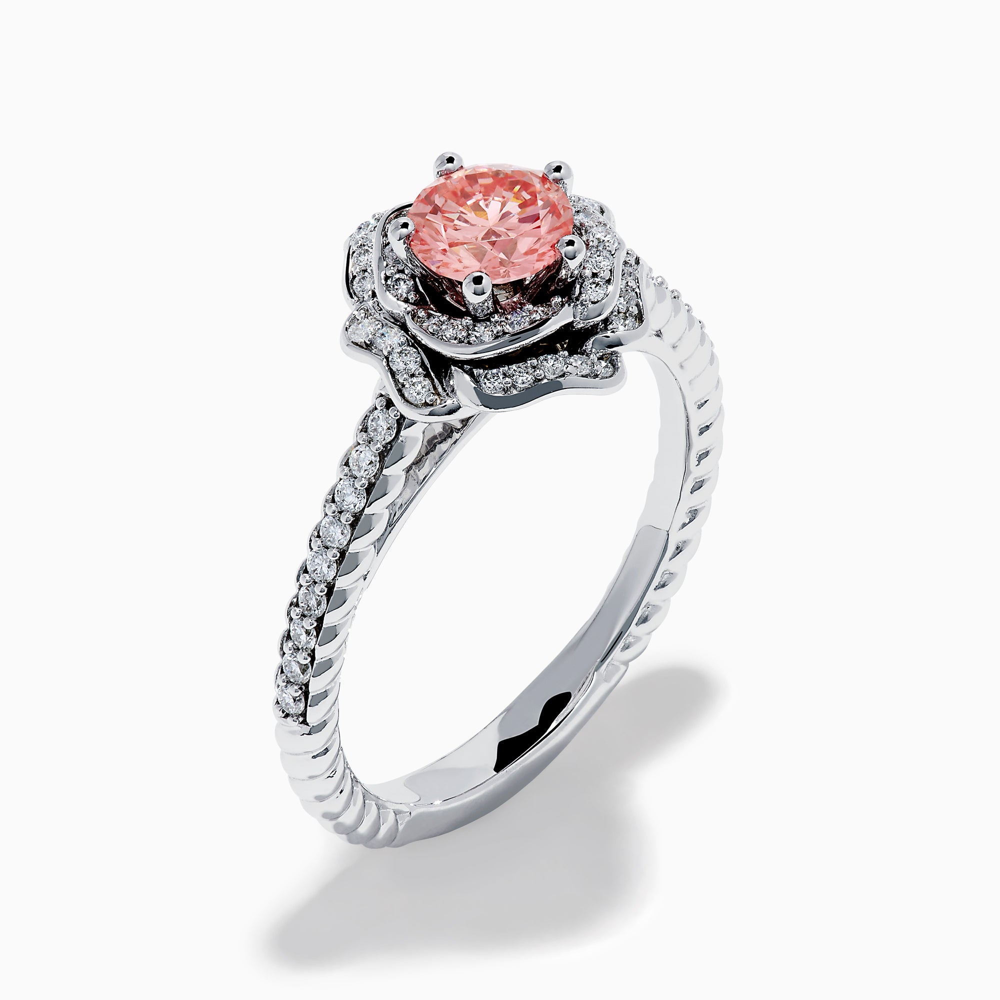 The Lab Grown Pink and White Diamond Rose Ring in 14K White Gold features a round pink center stone, a floral halo of lab grown diamonds, and additional diamonds along the band.