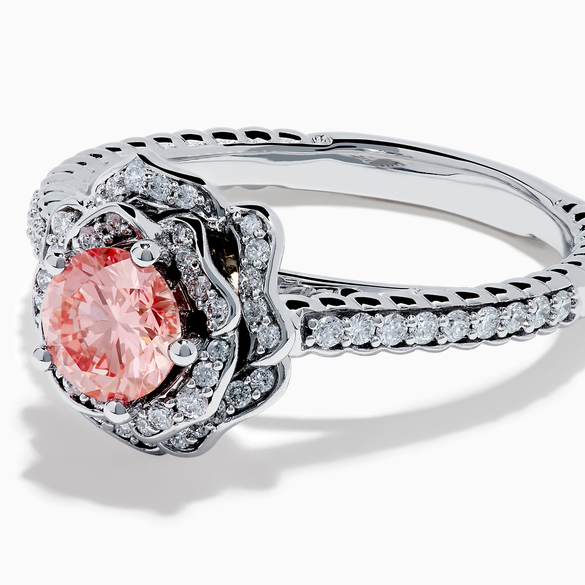 The Lab Grown Pink and White Diamond Rose Ring in 14K White Gold features a round pink center stone, a floral halo of lab grown diamonds, and additional diamonds along the band.
