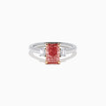 The Lab Grown Pink and White Diamond 3 Stone Ring in 14K White Gold features a rectangular pink and white diamond centerpiece with two clear baguette-cut side stones, set on a simple, elegant band.