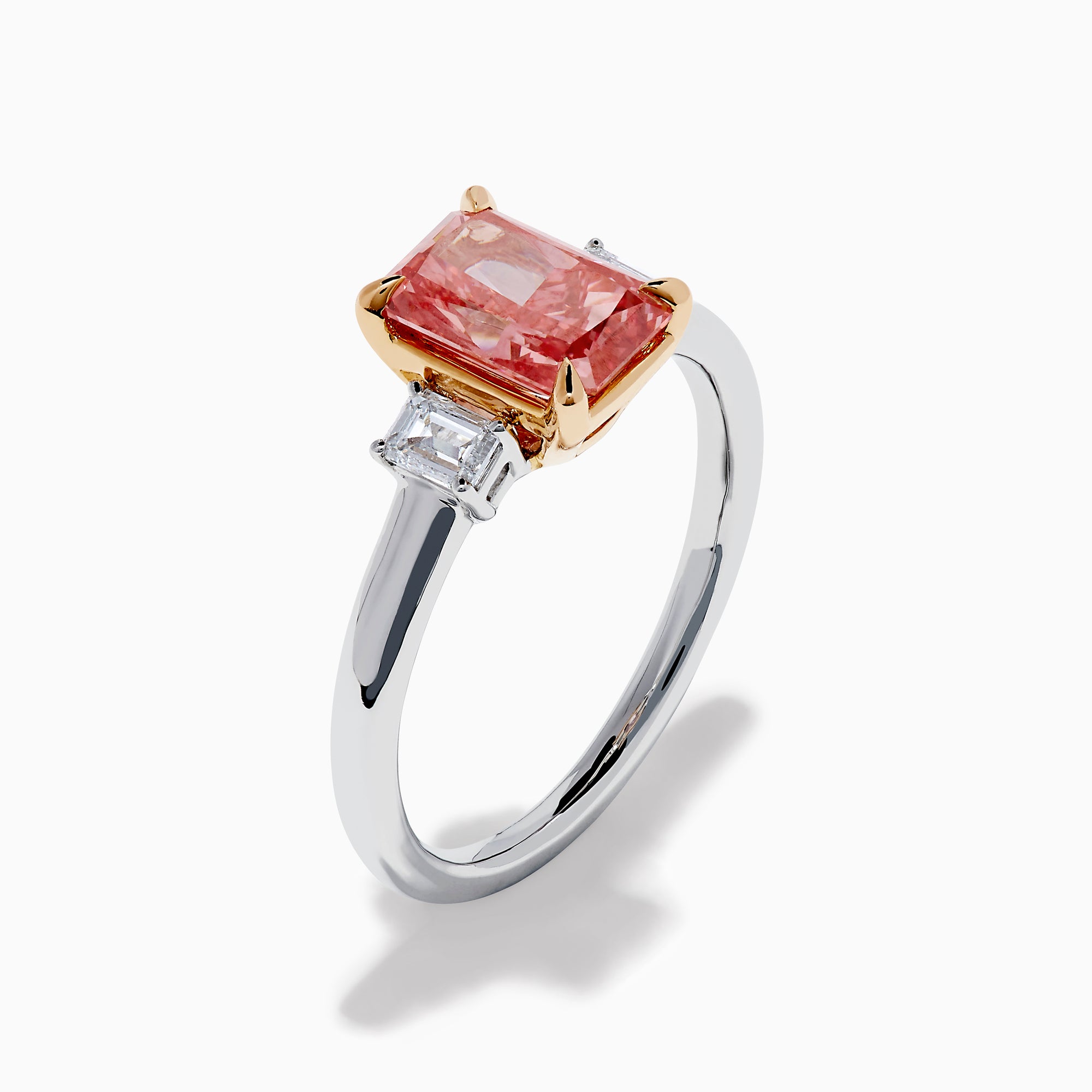 The Lab Grown Pink and White Diamond 3 Stone Ring in 14K White Gold features a rectangular pink and white diamond centerpiece with two clear baguette-cut side stones, set on a simple, elegant band.
