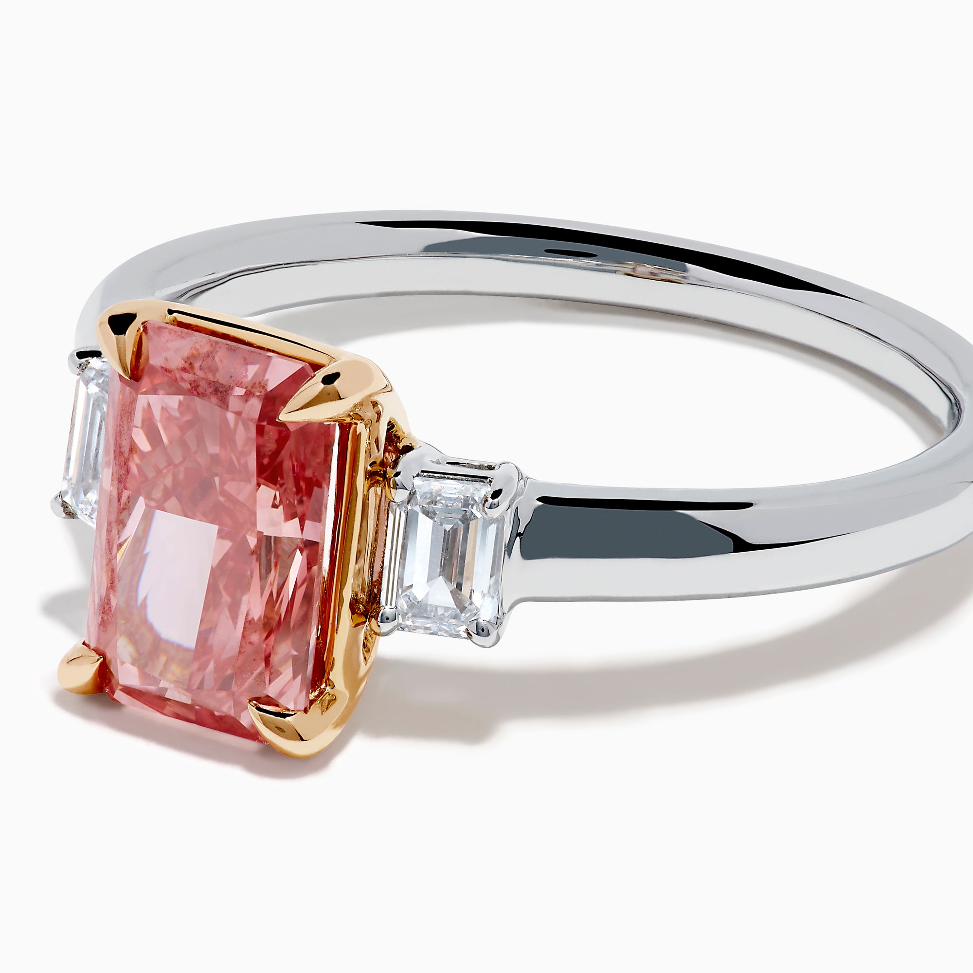 The Lab Grown Pink and White Diamond 3 Stone Ring in 14K White Gold features a rectangular pink and white diamond centerpiece with two clear baguette-cut side stones, set on a simple, elegant band.