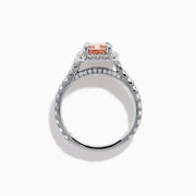 The Lab Grown Pink and White Diamond Halo Ring in 14K White Gold features a rectangular pink gemstone, a halo of lab grown diamonds, and a diamond-studded band, elegantly showcased on a white background.