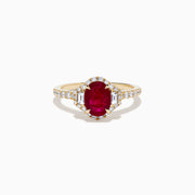 The Ruby Royale 14K Yellow Gold Ruby and Diamond 3 Stone Ring showcases a central oval ruby flanked by sparkling diamonds, set on a diamond-accented band and elegantly displayed against a white background.