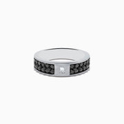The 14K White Gold Mens Black and White Diamond Ring features a 1.15 TCW square white diamond center, accented by small round black stones along the silver band for a bold black-and-white contrast.