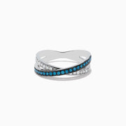 The Bella Bleu 14K White Gold Blue and White Diamond Ring, 0.57 TCW, showcases two crisscrossing bands—one with blue diamonds, the other with white—elegantly displayed against a plain white background.