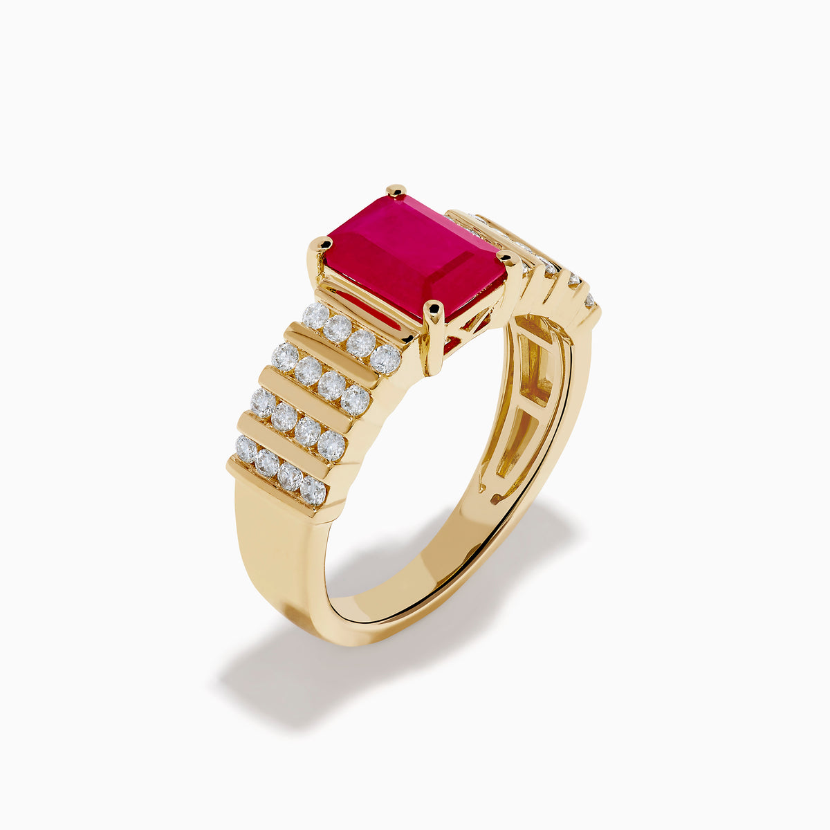 The Ruby Royale 14K Yellow Gold Ruby and Diamond Ring features a rectangular red ruby center, accented by three rows of small round diamonds on each side, all showcased against a white background.