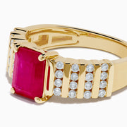 The Ruby Royale 14K Yellow Gold Ruby and Diamond Ring features a rectangular red ruby center, accented by three rows of small round diamonds on each side, all showcased against a white background.