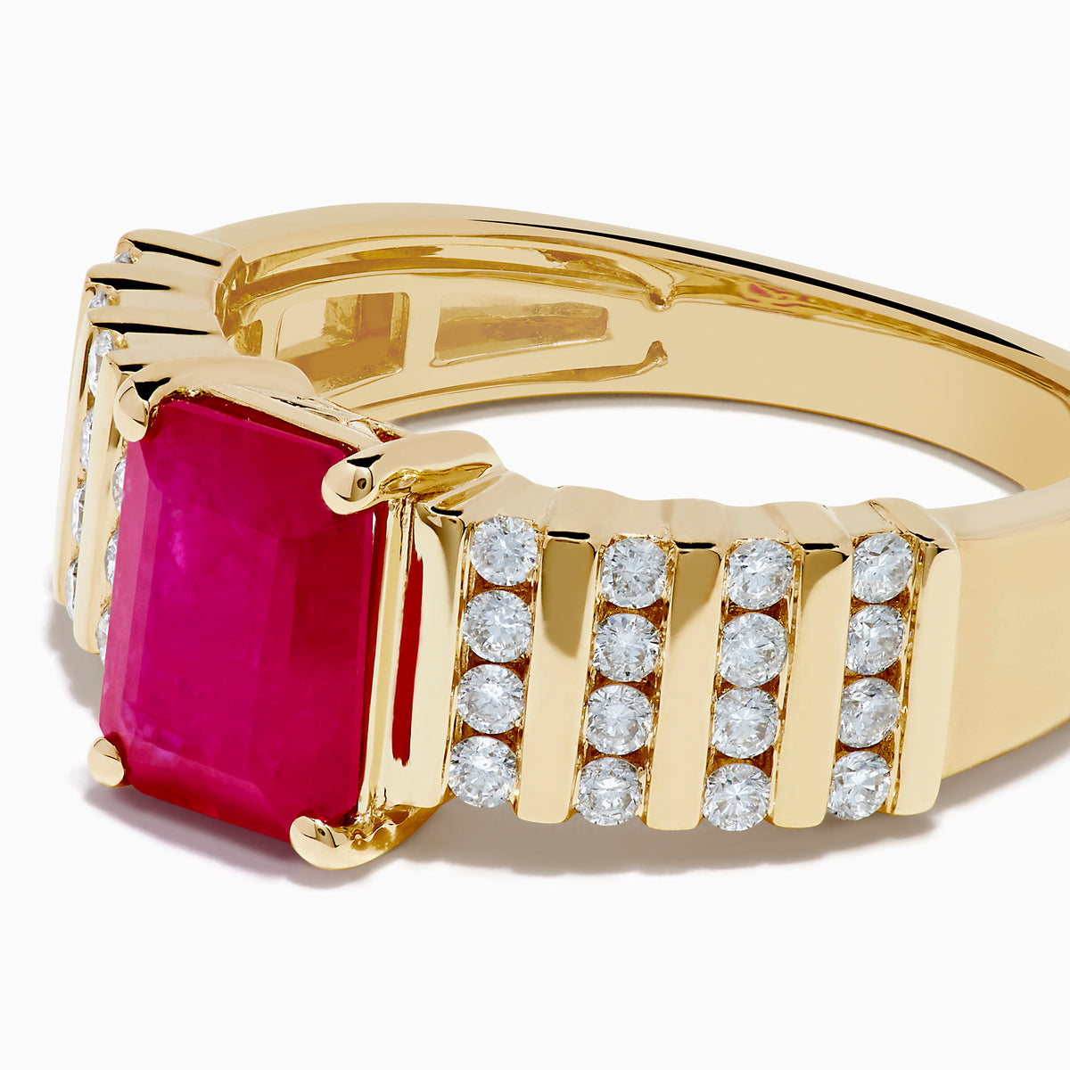 The Ruby Royale 14K Yellow Gold Ruby and Diamond Ring features a rectangular red ruby center, accented by three rows of small round diamonds on each side, all showcased against a white background.