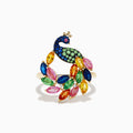 The Watercolors 14K Yellow Gold Multi Sapphire Peacock Ring features a vibrant peacock design with blue, green, pink, yellow, and orange sapphires, capturing the beauty of the bird’s feathered tail against a crisp white background.