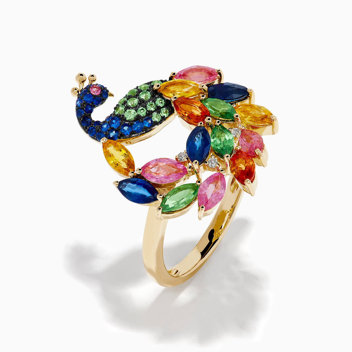 The Watercolors 14K Yellow Gold Multi Sapphire Peacock Ring features a vibrant peacock design with blue, green, pink, yellow, and orange sapphires, capturing the beauty of the bird’s feathered tail against a crisp white background.