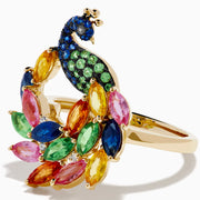 The Watercolors 14K Yellow Gold Multi Sapphire Peacock Ring features a vibrant peacock design with blue, green, pink, yellow, and orange sapphires, capturing the beauty of the bird’s feathered tail against a crisp white background.