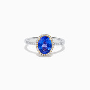 The Nahla 14K Two Tone Gold Tanzanite and Diamond Halo Ring features an oval blue tanzanite center, encircled by a diamond halo and diamond-accented band, all set in elegant two-tone 14K gold.