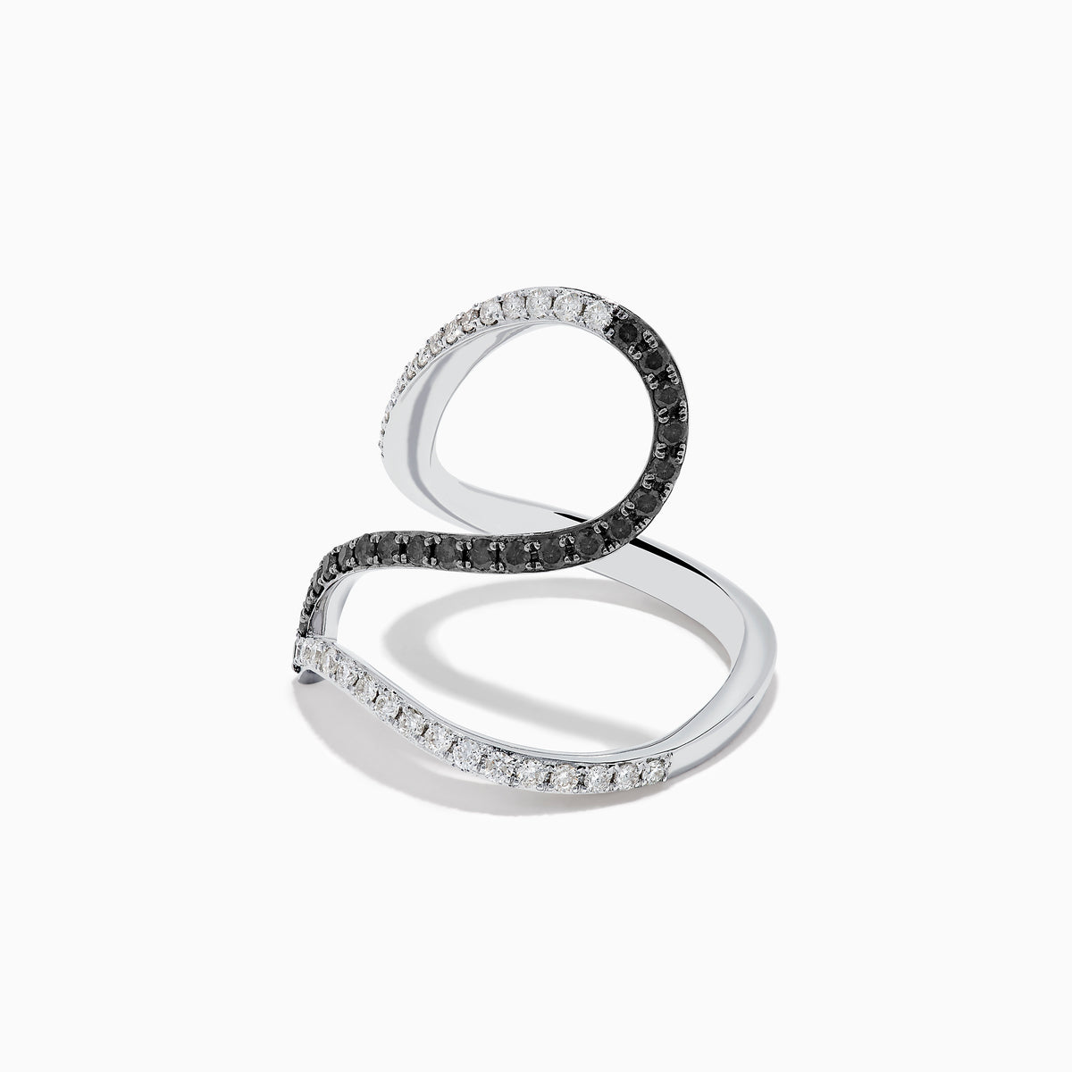 The 14K White Gold Black and White Diamond Fashion Ring features an open, wavy design with intertwined bands of sparkling white and black diamonds, creating a modern and elegant look.
