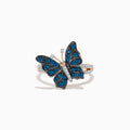 The Bella Bleu 14K Rose Gold White and Blue Diamond Butterfly Ring features blue diamonds on the wings, clear stones on the body, and a mix of rose gold and silver tones, elegantly displayed on a white background.
