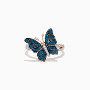 The Bella Bleu 14K Rose Gold White and Blue Diamond Butterfly Ring features blue diamonds on the wings, clear stones on the body, and a mix of rose gold and silver tones, elegantly displayed on a white background.
