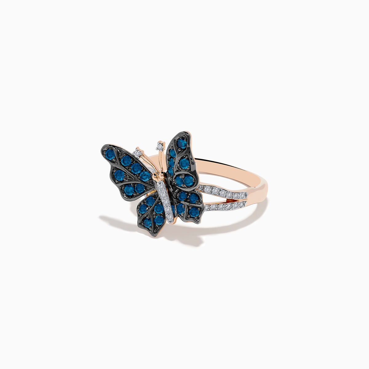 The Bella Bleu 14K Rose Gold White and Blue Diamond Butterfly Ring features blue diamonds on the wings, clear stones on the body, and a mix of rose gold and silver tones, elegantly displayed on a white background.