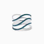 The Bella Bleu 14K White Gold Blue and White Diamond Ring, 0.47 TCW, features four wavy, interlaced bands—two with blue diamonds and two with white diamonds—elegantly set against a plain white background.