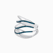 The Bella Bleu 14K White Gold Blue and White Diamond Ring, 0.47 TCW, features four wavy, interlaced bands—two with blue diamonds and two with white diamonds—elegantly set against a plain white background.