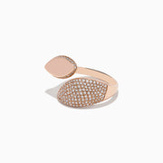 The Pave Rose 14k Rose Gold Open Shank Diamond Bypass Ring features two marquise-shaped ends—one polished, one with sparkling diamonds—shown elegantly on a white background.