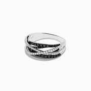A 14K White Gold Black and White Diamond Ring (.72 TCW) with intertwined bands—one adorned with black diamonds, the other with white stones—displayed against a plain white background.