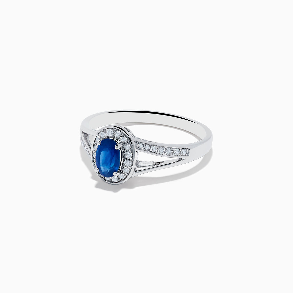 The Royale Bleu 14K White Gold Sapphire and Diamond Ring, 0.70 TCW, showcases an oval sapphire center with a diamond halo and a split shank band set with sparkling diamonds.