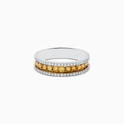 The Canare 14K Two Tone Gold Yellow and White Diamond Ring, 0.58 TCW, displays a central row of yellow diamonds bordered by white diamonds, elegantly showcased against a white background.