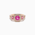 The 14K Rose Gold Pink Sapphire and Diamond Ring features a round pink sapphire center, accented by small diamonds and rectangular pink stones on each side of the band.